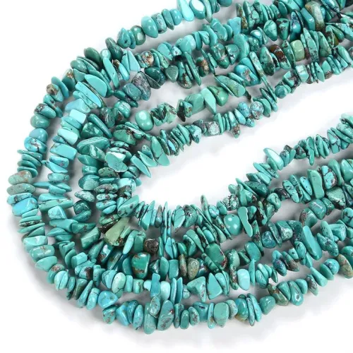 Geometric rug with turquoise and coral accents coordinating with jewelry